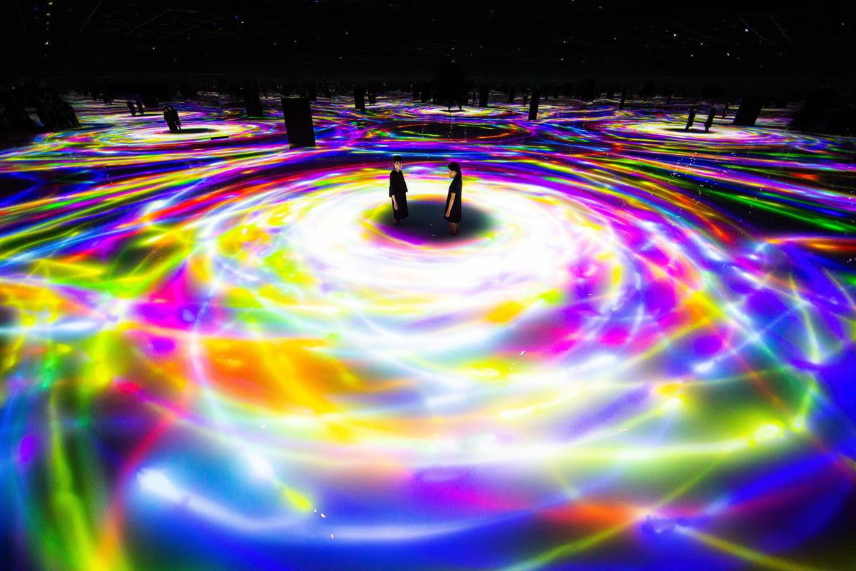Mist and light projections drifting over dark water at Drawing on the Water Surface